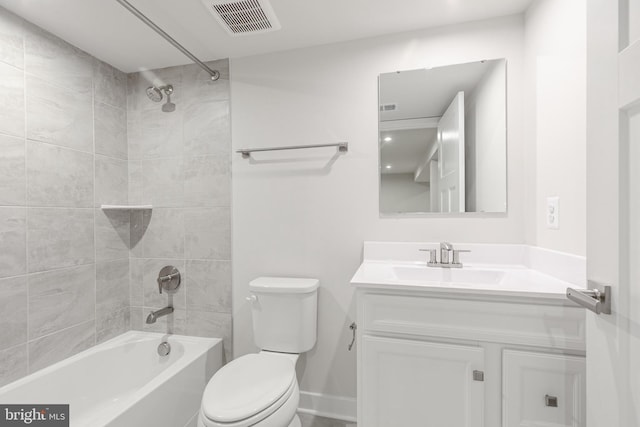 full bathroom with vanity, tiled shower / bath combo, and toilet