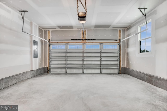 garage with a garage door opener and electric panel