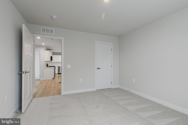 unfurnished bedroom featuring light colored carpet