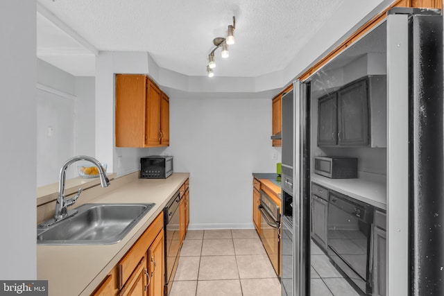 kitchen featuring a sink, light countertops, brown cabinets, dishwasher, and stainless steel microwave