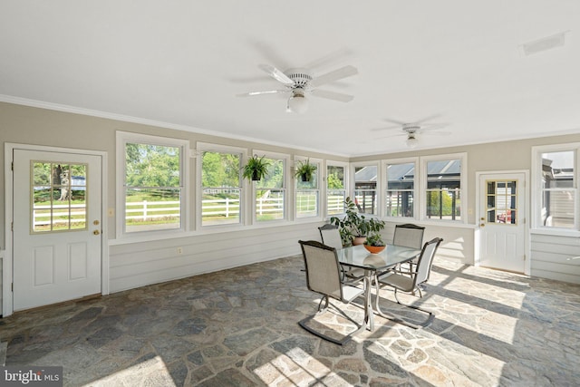 sunroom / solarium featuring a ceiling fan and visible vents