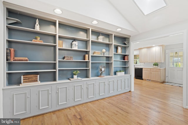 interior space with lofted ceiling and light wood-style flooring