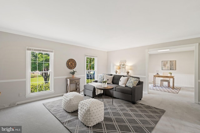 carpeted living room with ornamental molding, a wealth of natural light, and visible vents