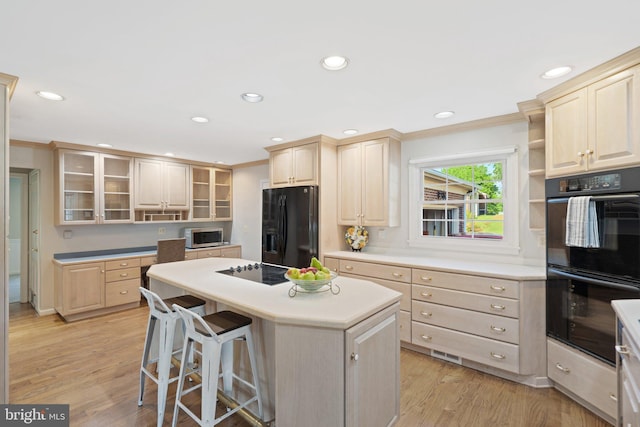 kitchen featuring light brown cabinets, black appliances, a kitchen island, and open shelves