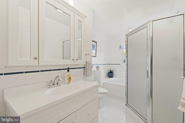 bathroom featuring toilet, a shower stall, vanity, tile patterned flooring, and a bath