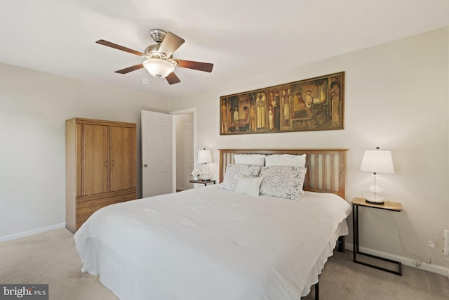 bedroom featuring light carpet, ceiling fan, and baseboards