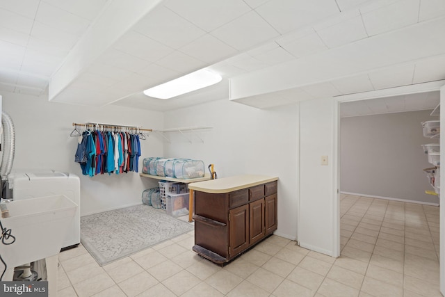 interior space featuring washer and clothes dryer and light tile patterned flooring