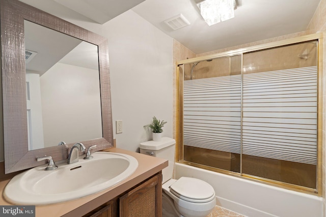 full bath with visible vents, combined bath / shower with glass door, vanity, and toilet