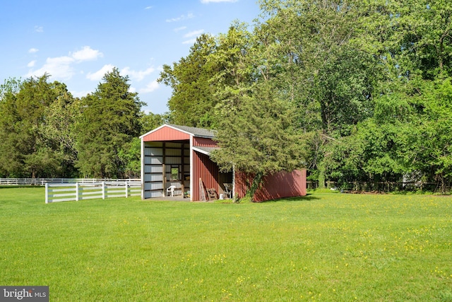 view of yard featuring an outbuilding and fence