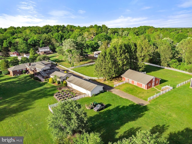 bird's eye view with a wooded view