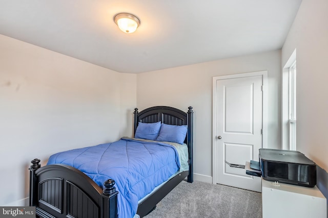 bedroom featuring carpet and baseboards