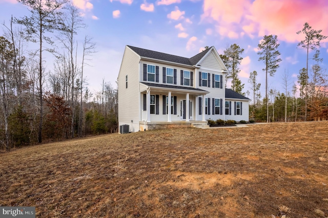 view of front of home with central air condition unit and a porch