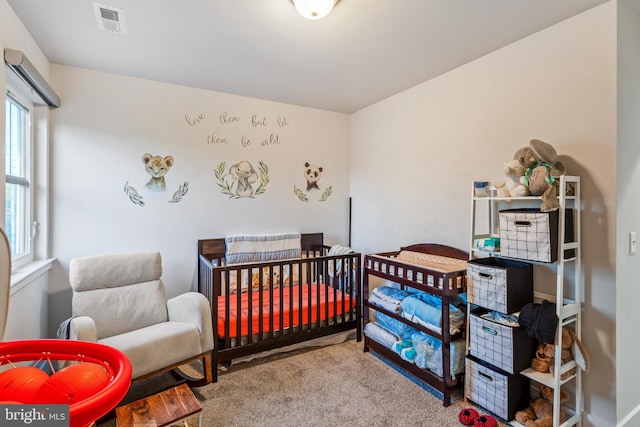 carpeted bedroom featuring visible vents