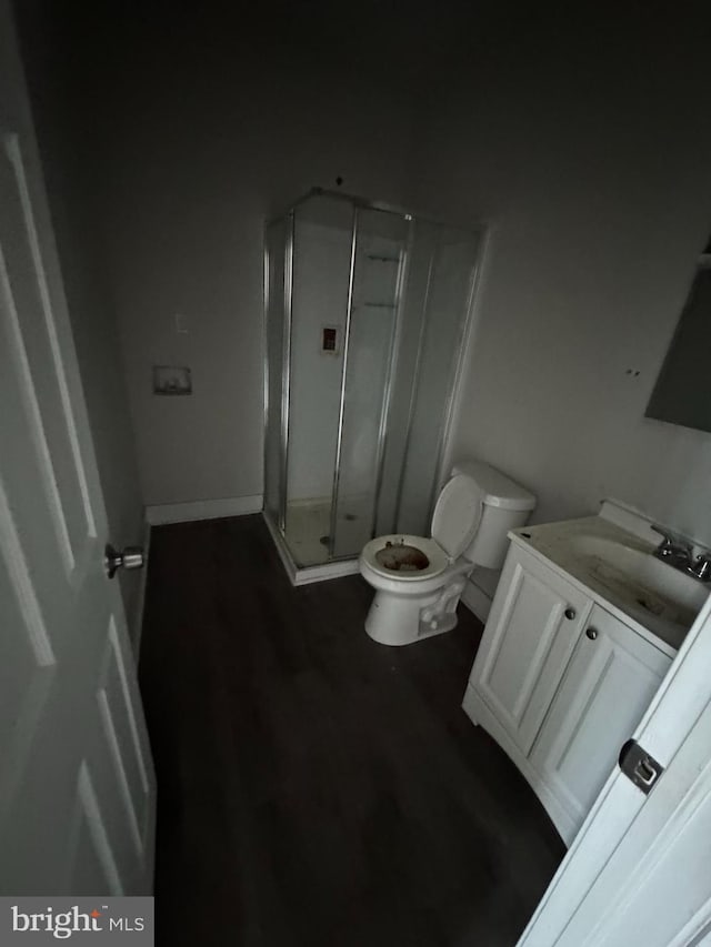 bathroom with vanity, toilet, and an enclosed shower