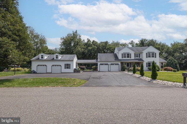 view of front of property featuring a garage and a front lawn