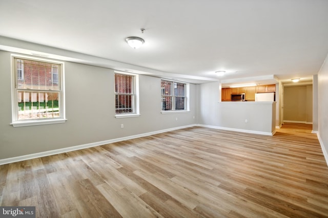 unfurnished living room with light hardwood / wood-style flooring