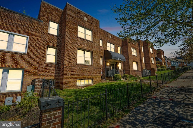 view of outdoor building at dusk