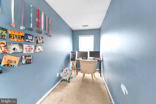 carpeted office space with visible vents and baseboards