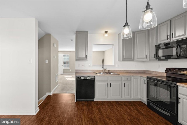 kitchen featuring pendant lighting, sink, gray cabinetry, black appliances, and dark hardwood / wood-style flooring