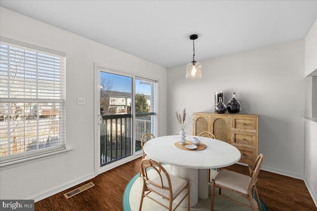 dining area with dark hardwood / wood-style floors