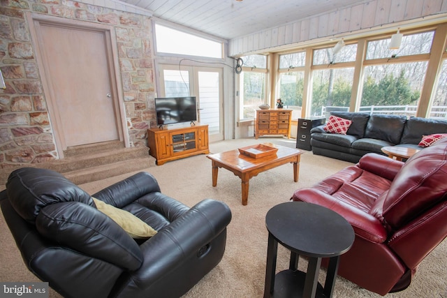 carpeted living area featuring lofted ceiling and wood ceiling