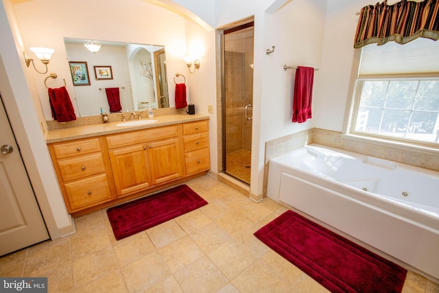 full bath featuring a stall shower, vanity, and a tub with jets