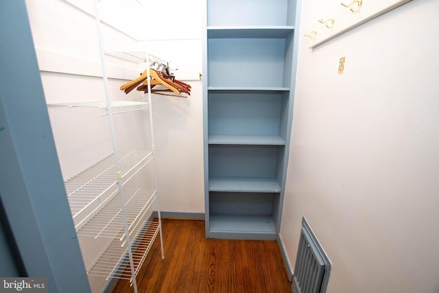 spacious closet with visible vents and dark wood finished floors