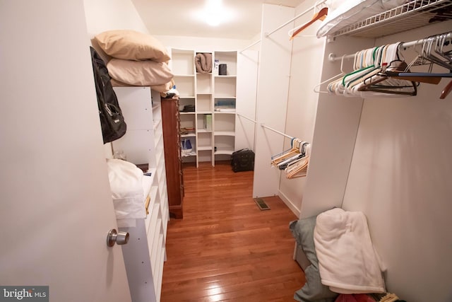 walk in closet featuring wood finished floors