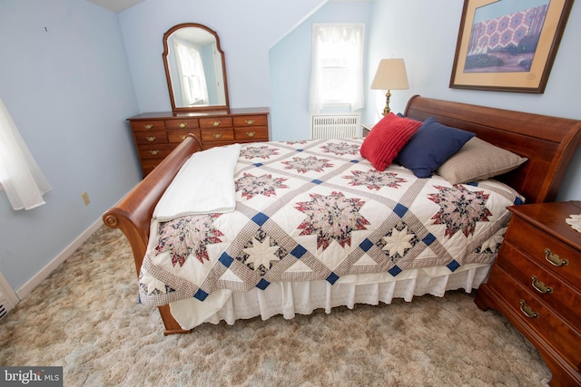 bedroom featuring light carpet, multiple windows, and baseboards