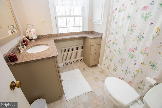 full bath featuring radiator, a shower with shower curtain, vanity, and toilet