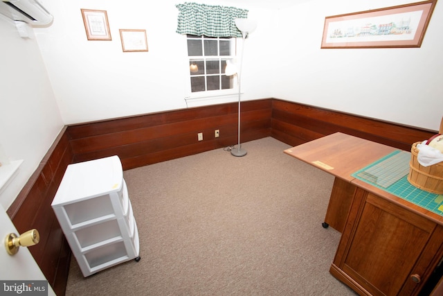 unfurnished office with a wainscoted wall, wooden walls, an AC wall unit, and light colored carpet