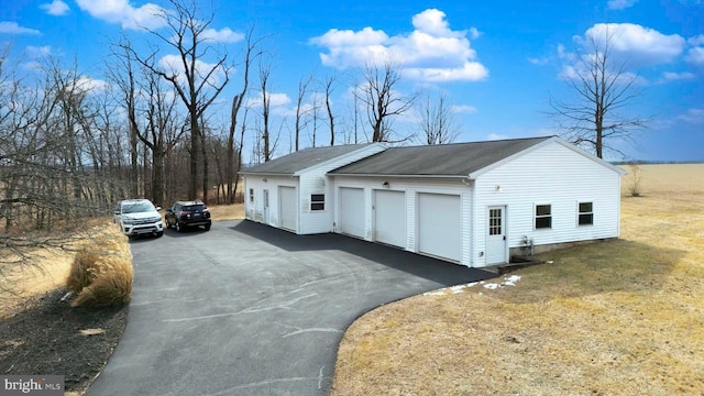 view of home's exterior with a garage and a lawn