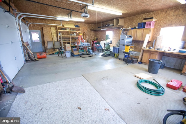 garage featuring a workshop area and a garage door opener