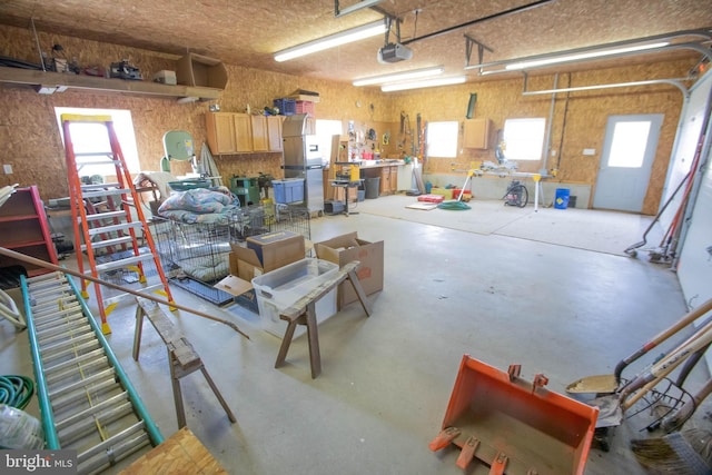 garage featuring a workshop area and a garage door opener