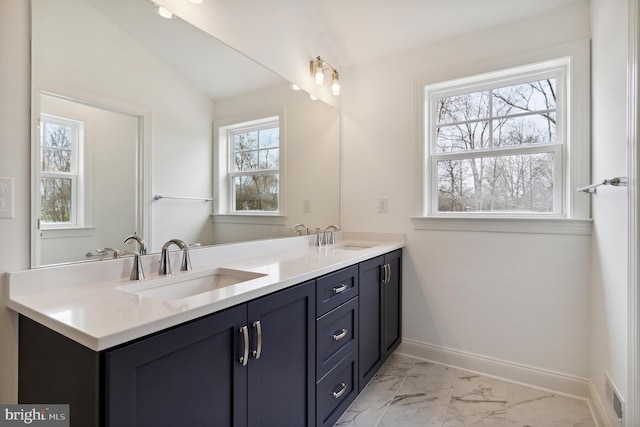 bathroom featuring vanity and lofted ceiling