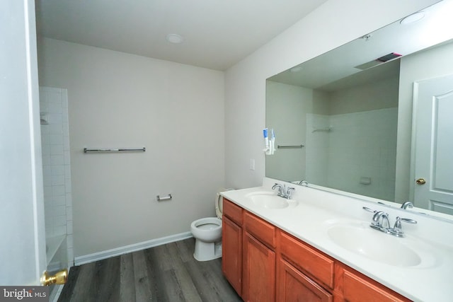 full bathroom with vanity, tub / shower combination, hardwood / wood-style floors, and toilet