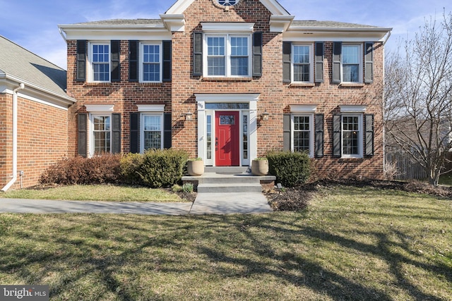 view of front of house featuring a front yard and brick siding