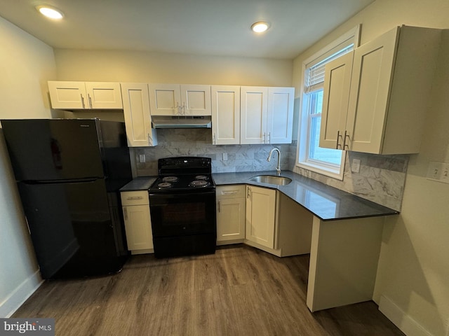 kitchen with sink, white cabinetry, hardwood / wood-style flooring, decorative backsplash, and black appliances