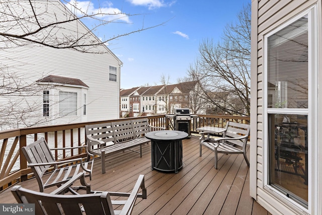 wooden deck with grilling area and a residential view