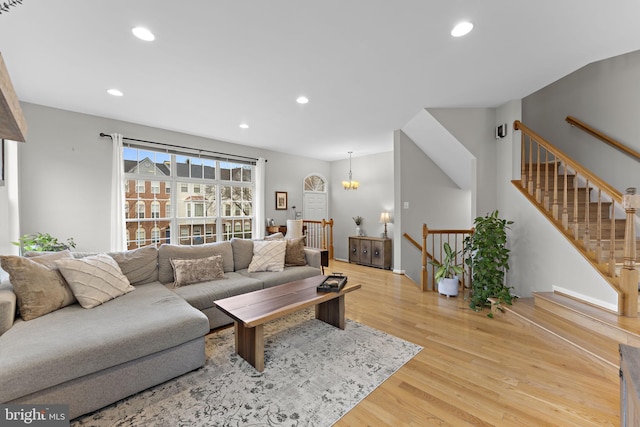 living area with recessed lighting and light wood-style flooring