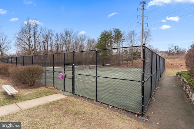 view of sport court featuring fence