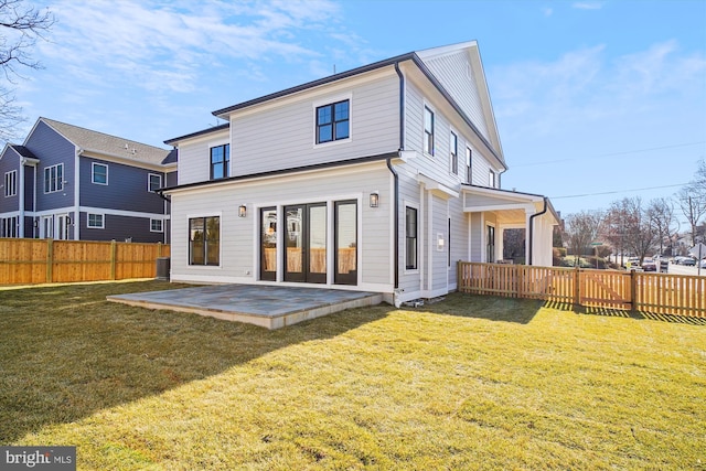 back of property featuring a yard and a patio