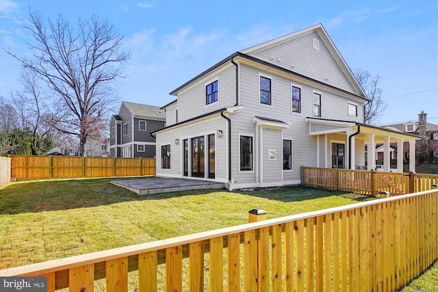 rear view of house featuring a lawn