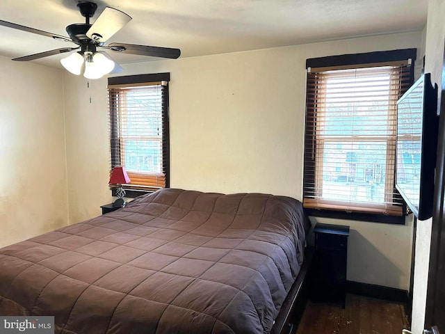 bedroom featuring dark hardwood / wood-style flooring and ceiling fan