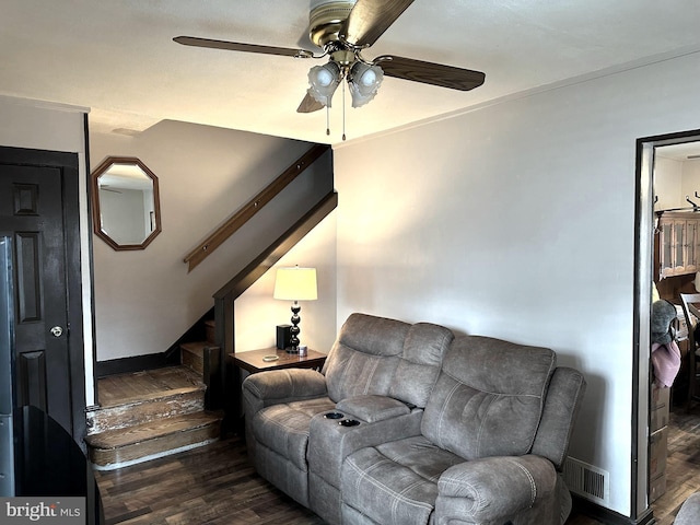 living room featuring ceiling fan and dark wood-type flooring