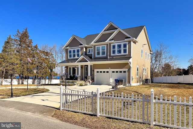 craftsman-style home with a garage, central AC unit, and covered porch