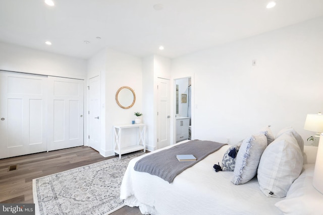 bedroom featuring hardwood / wood-style floors and a closet