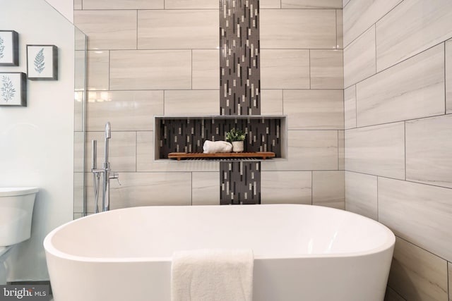 bathroom featuring a tub and toilet