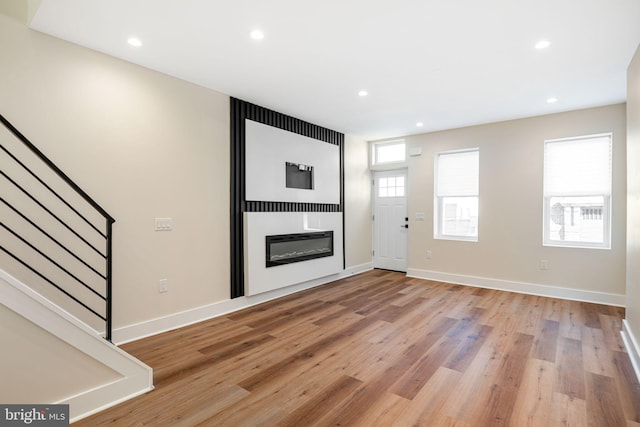 unfurnished living room featuring light wood-type flooring