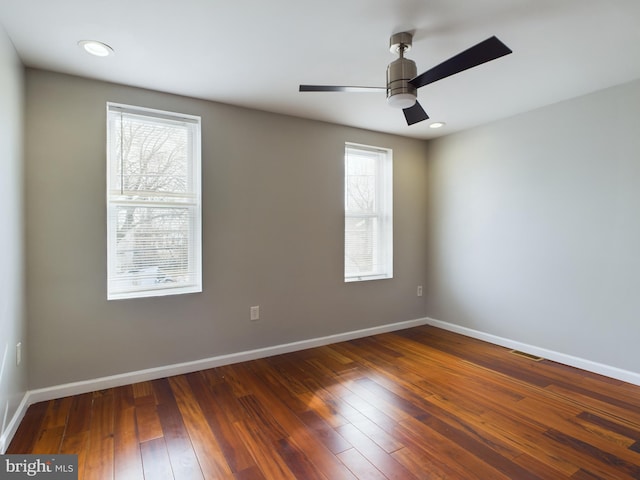 unfurnished room with dark hardwood / wood-style floors and ceiling fan